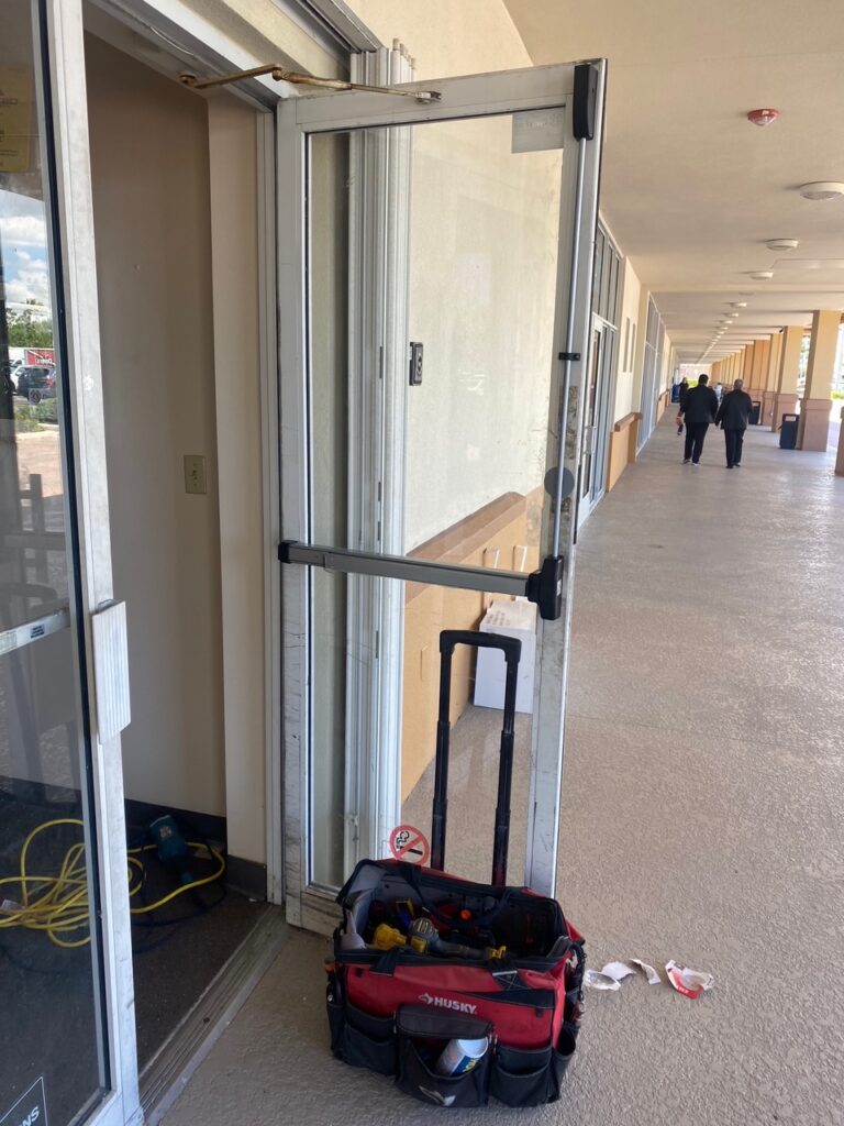 Detailed installation of a Falcon 19–R-EO Narrow Stile Rim Exit Device by 24/7 Super Locksmith, your leading Commercial Locksmith in West Palm Beach, FL. We specialize in panic bar hardware and commercial Lock Repair in Delray Beach, FL for retail and office buildings.